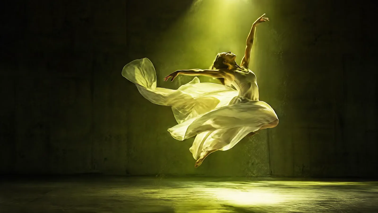 Veo 3.1 Fast example: Dancer in white landing a leap in a lime spotlight